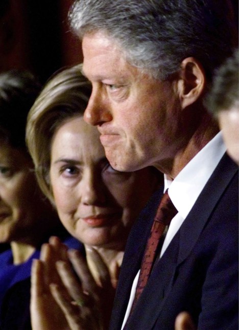 Former U.S. first lady Hillary Clinton (L) looks at her husband, President Bill Clinton, immediately following his address to the National Prayer Breakfast in Washington DC in this February 4, 1999 file photo. U.S. Senator Hillary Clinton (D-NY) in her soon to be published book "Living History," said that when Bill Clinton told her of the relationship with Monica Lewinsky, "I could hardly breathe. Gulping for air, I started crying and yelling at him." REUTERS/Win McNamee/File